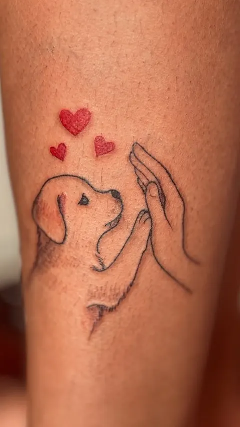 Filhote de cachorro encostando a pata numa mão, em traço fino, com corações vermelhos
